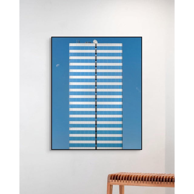 Two Moons by Marc Fischer presents a restrained architectural study defined by symmetry, repetition, and subtle visual...