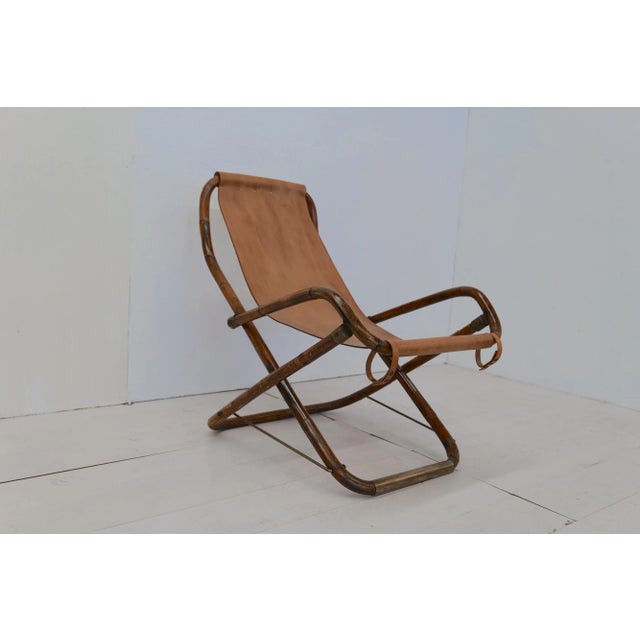 The Vintage Italian Leather and Wood Rocking Chair from the 1960s is a classic piece of furniture crafted in Italy. It...