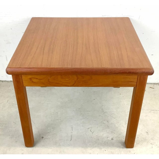 This Scandinavian Modern style end table is features clean modern lines and vintage teak finish and is the perfect square...