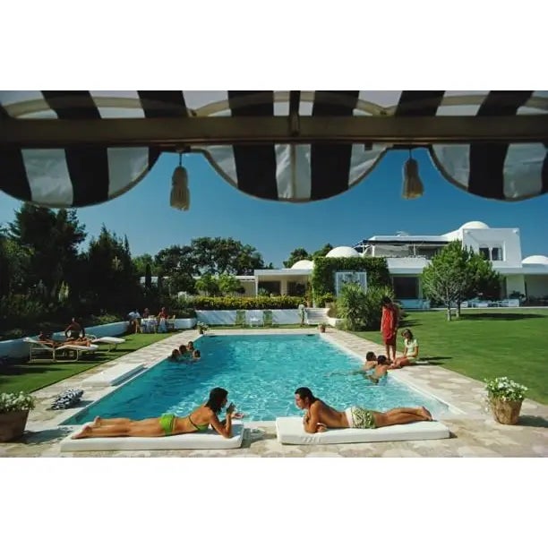 Poolside in Sotogrande 1975 Bathers round a pool in Sotogrande, Spain, August 1975. Photo by Slim Aarons Slim Aarons was...