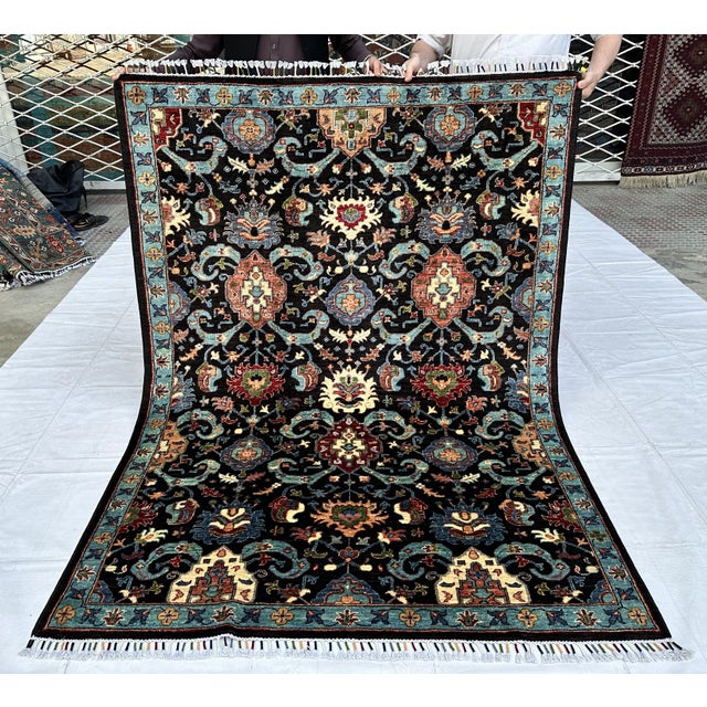 Persian Malayer design hand-knotted rug featuring a dramatic all-over repeat of coral and turquoise medallions connected...