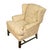 Upholstered English wingback chair in a neutral cream floral fabric and straight mahogany legs