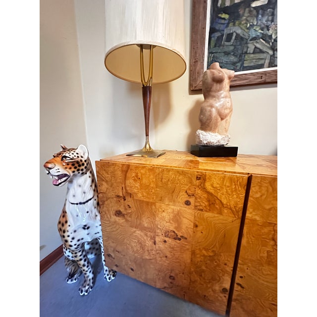 Very large pink marble female form, beautifully rendered curves, emerging from a chunky chisel-texture base a top a black...