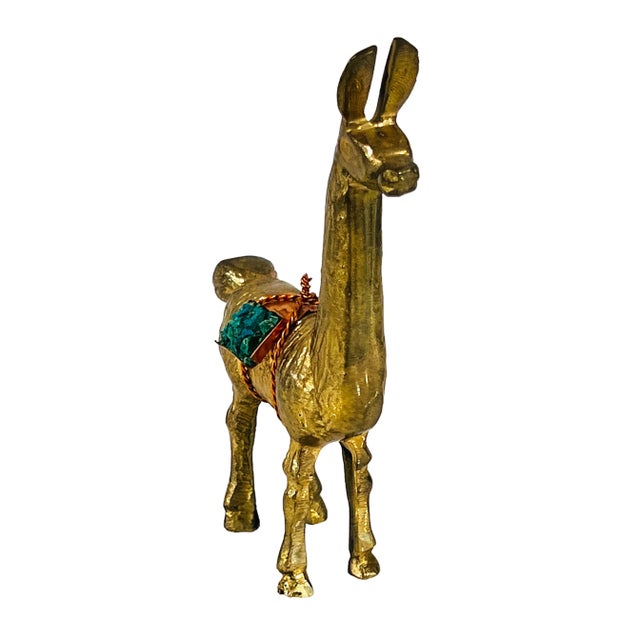 Cute solid brass llama figurine with copper sack filled with turquoise nuggets. No makers mark. Light age patina.