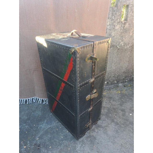 Antique vertical travel trunk, a wardrobe trunk from the early to mid-20th century (circa 1920s–1940s). Made of wood...