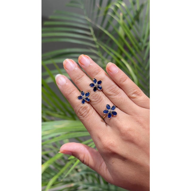 Floral blue sapphire studs in 18K gold create a subtle beauty while showcasing the colors of the natural precious...