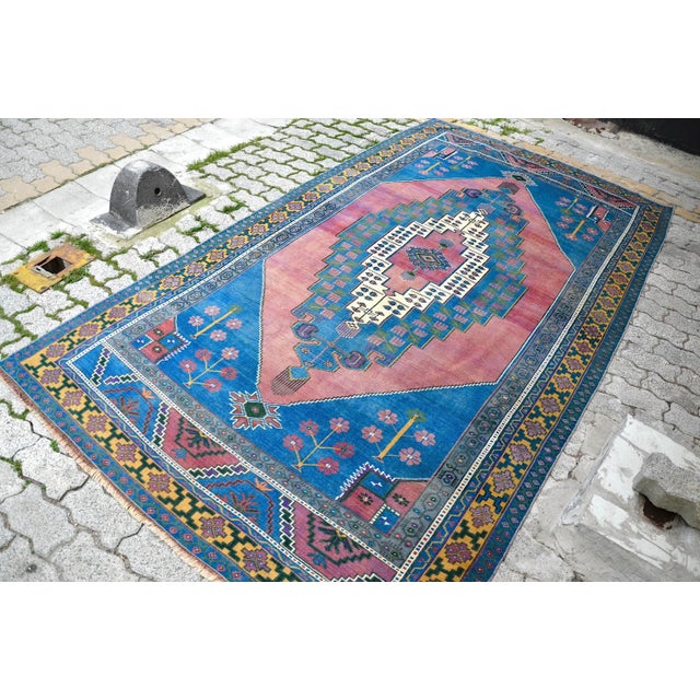 This is a vintage Turkish Oushak rug from the 1960s. The piece was hand-knotted.