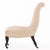 featuring a graceful arched back and low seat raised on turned ebonized legs terminating in brass casters. The chair has...