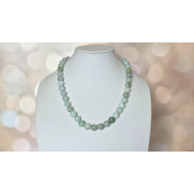A striking and timeless vintage necklace composed of natural Burmese jadeite jade beads, dating to approximately the...