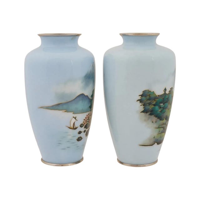 A pair of vintage Japanese cloisonne enamel vases dating to the mid 20th century, featuring a pale blue ground decorated...