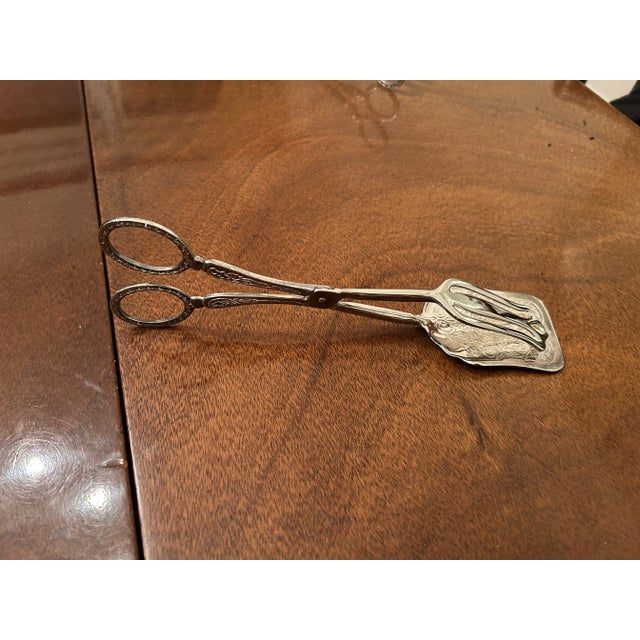 Beautiful 9" Vintage Silver-plate Dessert tongs or for serving dinner rolls. Scroll design. Some patina. If you like shiny...