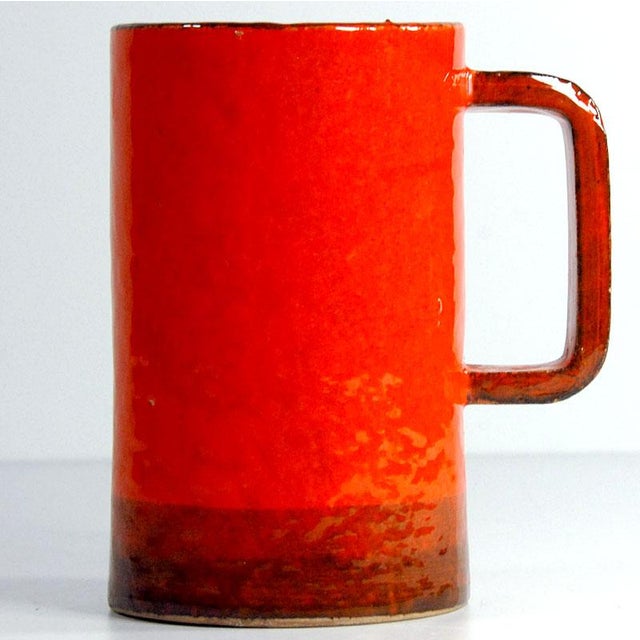 A large table vase made of ceramic decorated with sgraffito and glazed in colors known as Rimini Blue. The vase was...