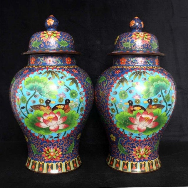 A striking large pair of Chinese Cloisonné Enamel "General Jars." These vibrant vessels feature a central panel of...