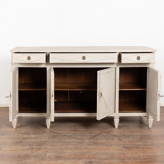 Swedish sideboard buffet with traditional diamond motif in drawers and door panels. Three drawers over four cabinet doors,...