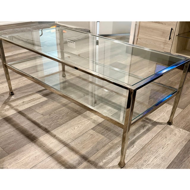 Modern 2-tier glass coffee table with a metal frame. No cracks or chips, just a few minor scratches on metal. Stock photos...