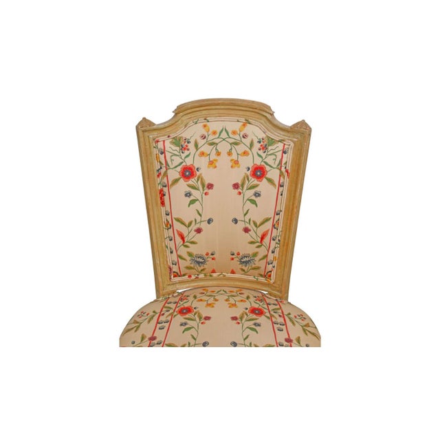 A set of eight Louis XVI style dining chairs: six side chairs and two armchairs. The painted frames have a soft, worn...