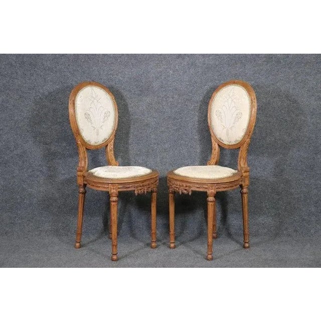 These are a beautiful pair of French-made Louis XVI side chairs. The chairs are in good condition with beautiful carving...