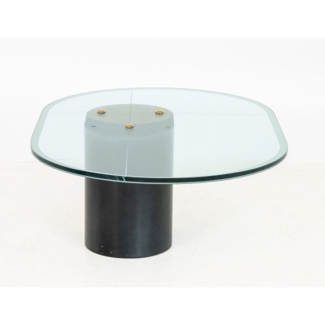 Karl Springer Attributed Oval Glass Coffee Table, the geometric frosted glass top above oval gold-leaf and black resin...
