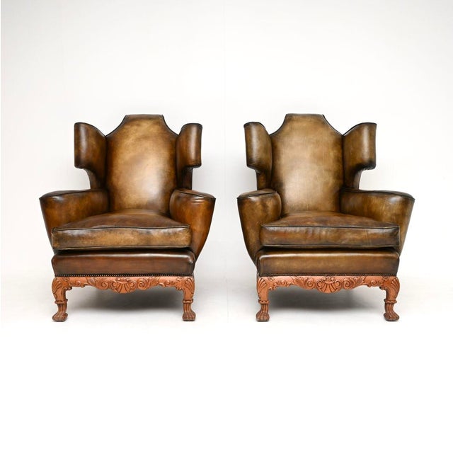 A magnificent pair of antique leather wing back armchairs, possibly the finest pair we have come across. They were made in...