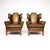 A magnificent pair of antique leather wing back armchairs, possibly the finest pair we have come across. They were made in...