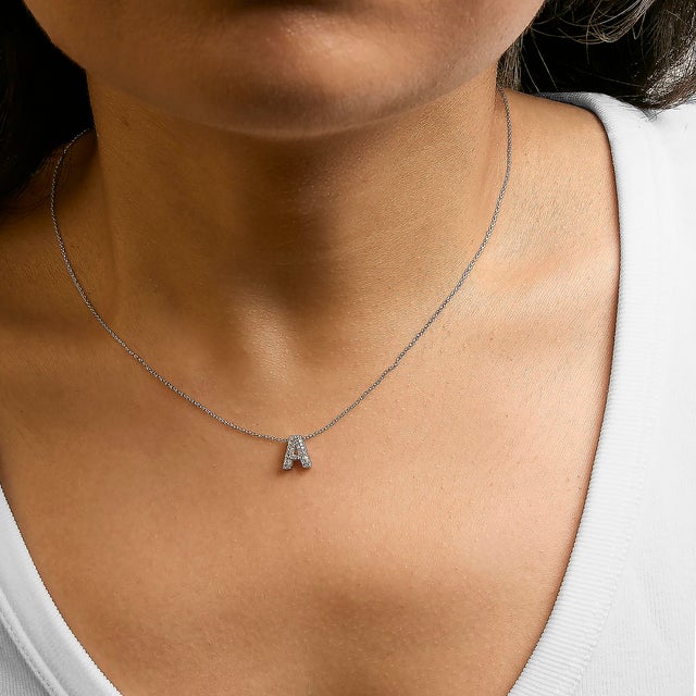 Elegance meets personalized charm in this exquisite pendant, meticulously crafted from radiant 10K white gold with a...