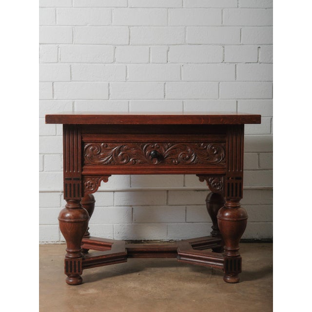 A richly carved Renaissance Revival oak table, crafted in the late 19th century and showcasing the grandeur and...