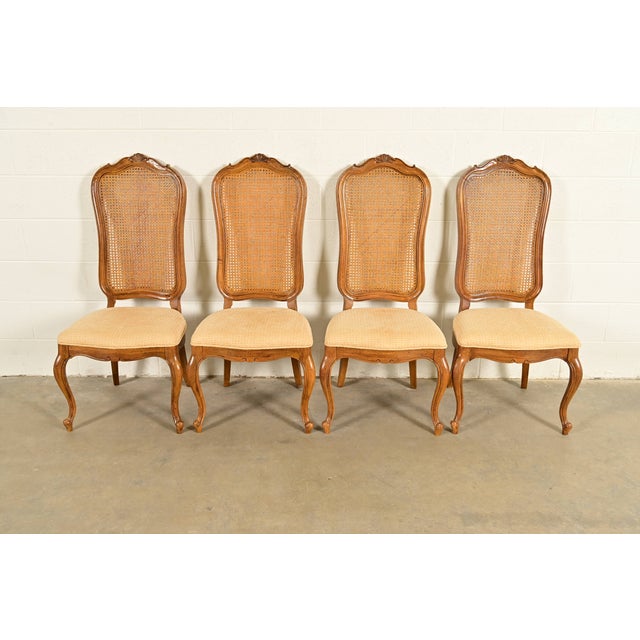 A gorgeous set of four French Provincial Louis XV style dining chairs By Thomasville USA, Circa 1960s Sculpted walnut...