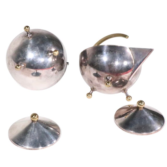 Late 20th Century Modern Danish design stainless steel and brass sugar and creamer designed by Carl Jorgensen for Bodum....