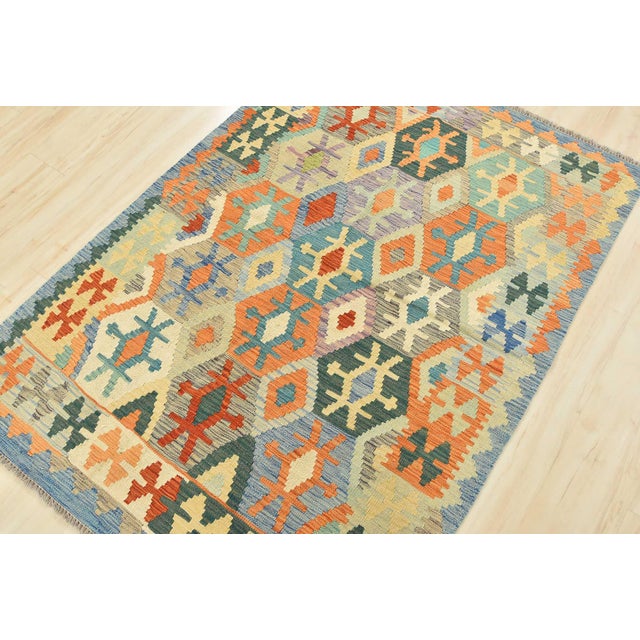 This tribal geometric Kilim rug is handwoven with all wool on a wool foundation. This rug is new and in excellent...