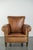 This unique antique sheepskin armchair is crafted in the English style and features a beautiful patina. The armchair has a...