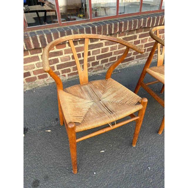 The classic CH 24 Wishbone Chair by Hans J. Wegner for Carl Hansen & Son of Denmark. This set of six chairs is from a very...