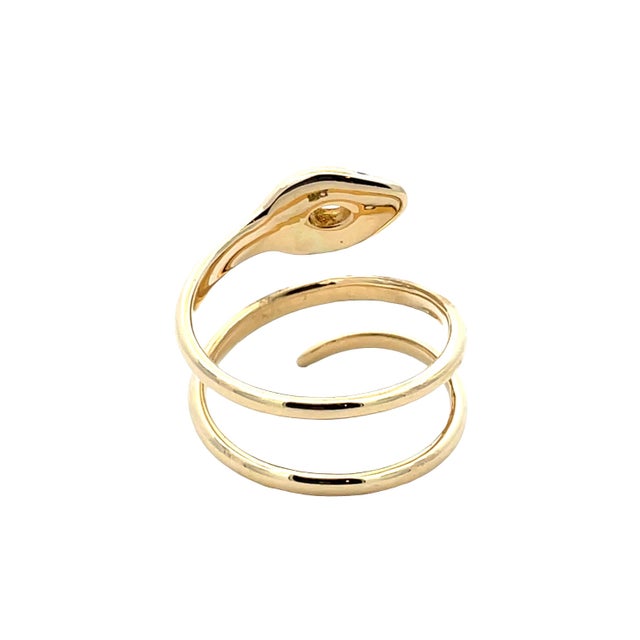 Elegant 18K yellow gold swirl snake ring featuring a marquise-cut diamond crown complemented by diamond eyes, with a total...