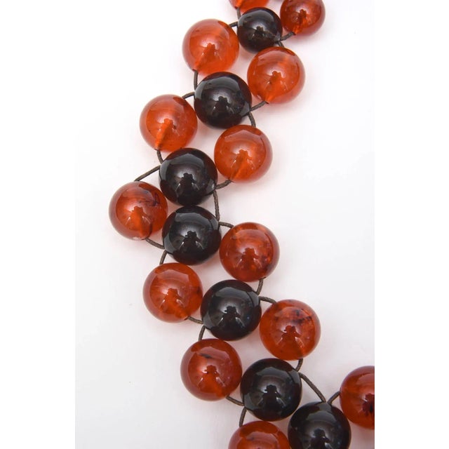 This is part of Chairish’s Costume Jewelry assortment. Orange-Amber and black purple resin balls make this fun vintage...