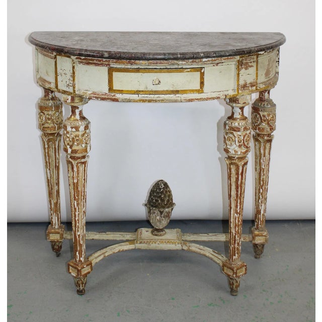A handsome 19th-century Louis XVI style painted and parcel-gilt demi-lune console table with an exceptional breccia marble...