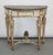 A handsome 19th-century Louis XVI style painted and parcel-gilt demi-lune console table with an exceptional breccia marble...