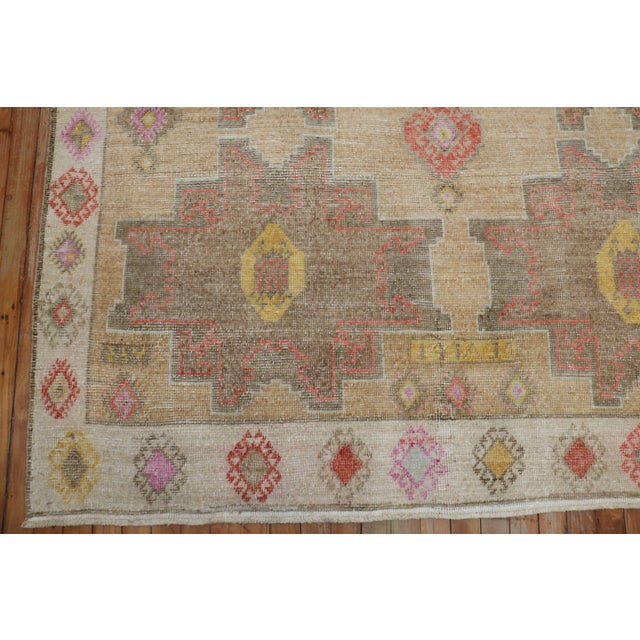 One of a kind corridor size Turkish Kars rug from the 20th century. A tan geometric field with multiple large scale tribal...