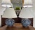 Classic blue and white ginger jar table lamps with dark wood fittings and shiny gold accents. Rigid white linen shades...