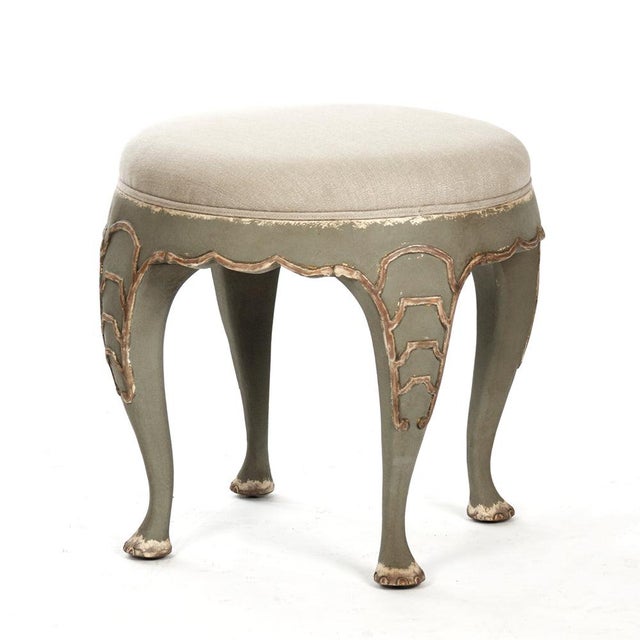 The Leo Stool from Zentique is a French country accent stool with a round natural linen seat on a distressed olive green...