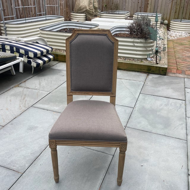 A beautifully crafted set of six Restoration Hardware Louis XVI–style dining chairs upholstered in soft Belgian linen,...