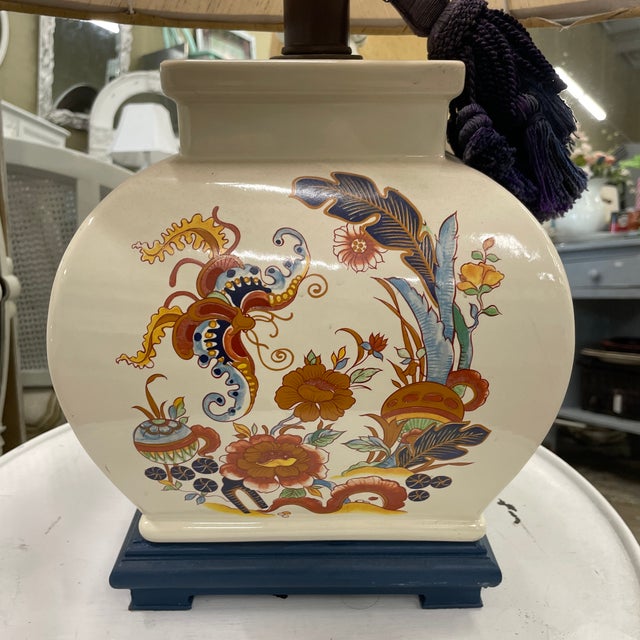 Incredibly unique vintage table lamp has a “curved square” design in a cream/taupe ceramic body and a painted wooden base....