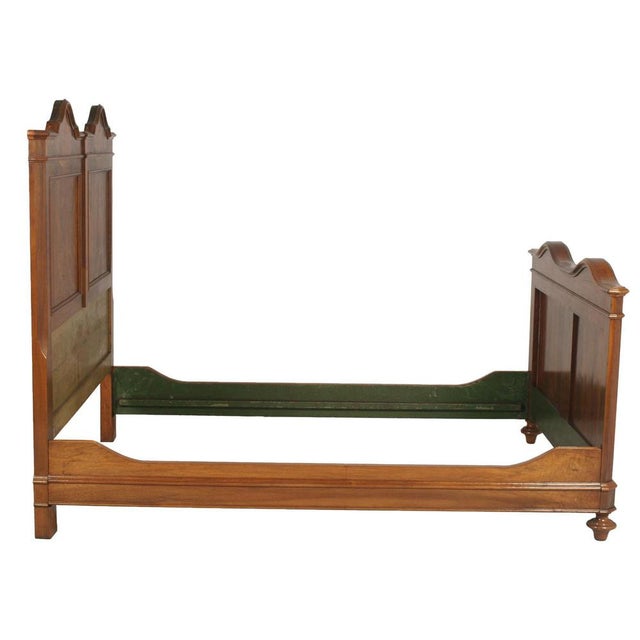 Elegant italian double bed in walnut and richly figured burl walnut, dating to the late 19th century and conceived in the...