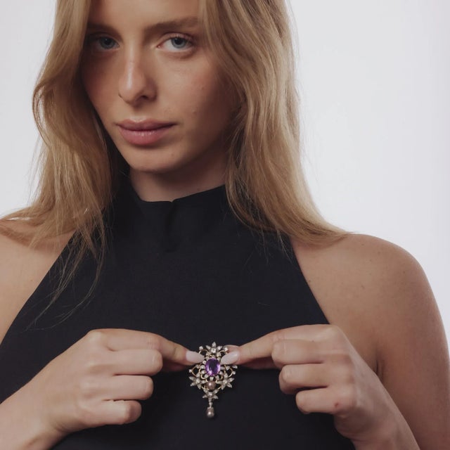 This Edwardian French brooch from the 1910’s is an exquisite blend of regal color and refined design. Centering a 6.80...