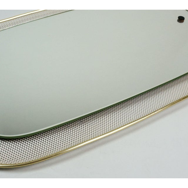 A very decorative mid-century wall mirror from the 1950s, unlabeled, presumably by Vereinigte Werkstätten. The back panel,...