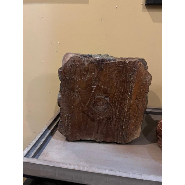 This beautifully hand-carved wooden decorative base showcasing a sculptural scalloped edge and a richly weathered painted...