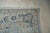 A 10' x 14' hand-knotted wool rug with a pale blue Oushak field of soft palmettes and vines, with navy and apricot accents...