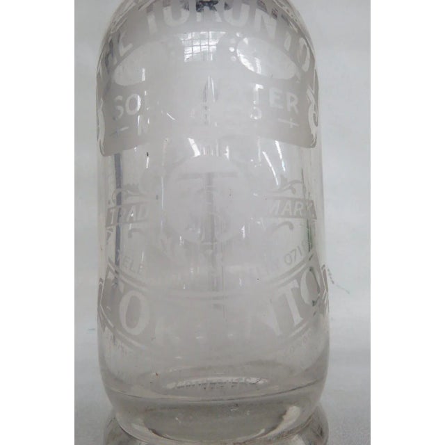 This Rare Seltzer Bottle is made out of glass with a metal topper. This Seltzer Bottle has a clean look with its...