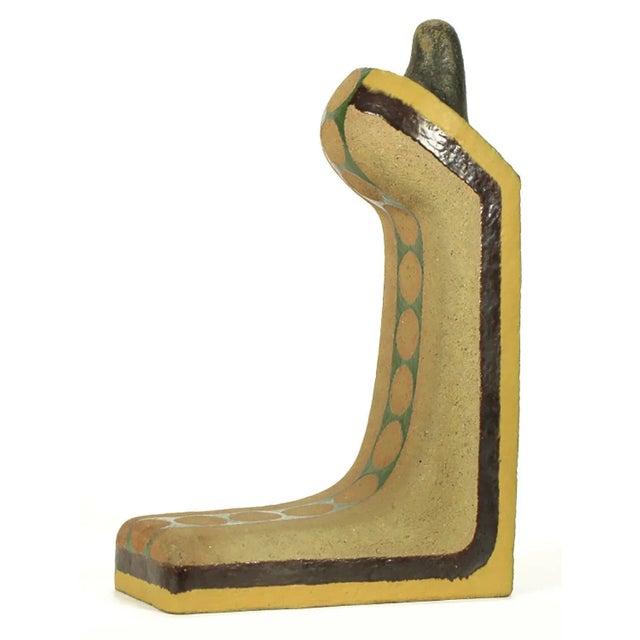 Abstract ceramic sculpture in parcel glazed finish of brown and yellow border with center dotted open green band. Reverse...