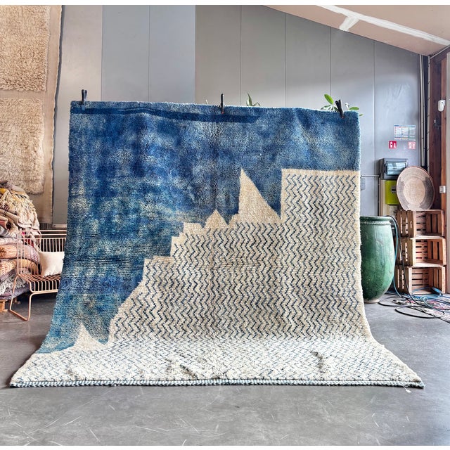 This large Moroccan Mrirt Beni Ouarain rug is a handwoven piece crafted by skilled artisans from the Middle Atlas region...