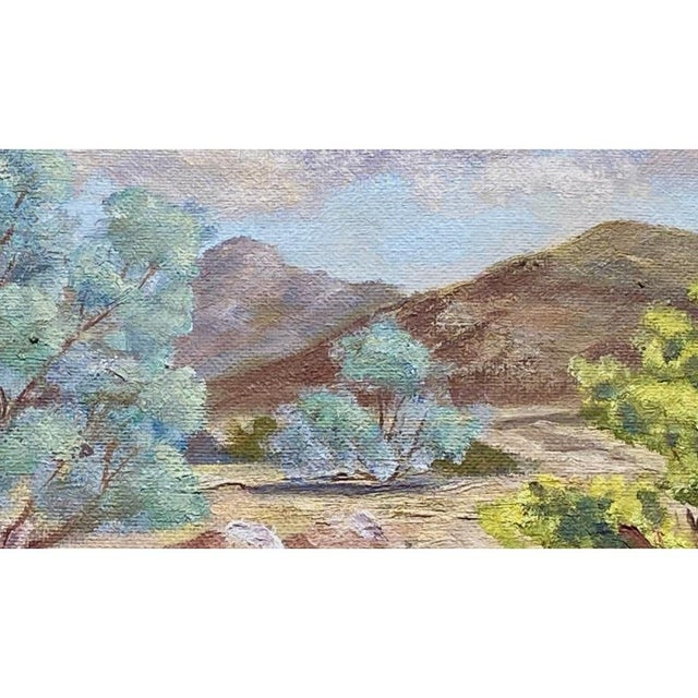 A beautifully composed vintage mid century oil painting, signed H.E. Cradock and dated 1969, featuring a serene desert...