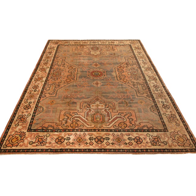 A 10x13 ode to rare antique Oushak rug styles, hand knotted in wool originating from Ireland circa 1920-1930. Representing...